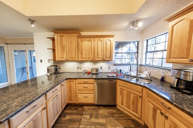 4001 Dyer Cir, Midland, TX 79707 - kitchen with stainless steel dishwasher, a sink, a textured ceiling, tasteful backsplash, and open shelves