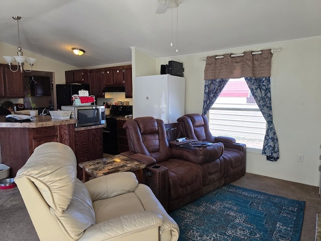 living room with lofted ceiling, ceiling fan with notable chandelier, and carpet floors