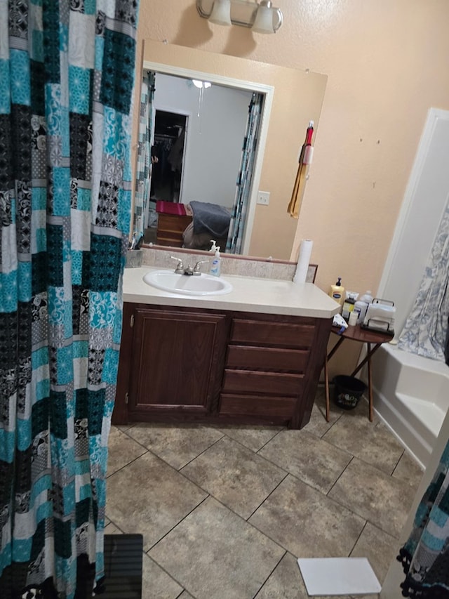 bathroom featuring tile patterned floors, curtained shower, and vanity