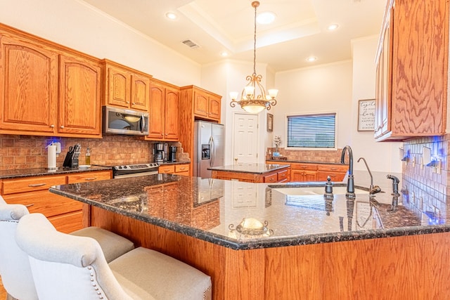 404 SW 21st St, Seminole, TX 79360 - kitchen featuring appliances with stainless steel finishes, ornamental molding, tasteful backsplash, a chandelier, and dark stone countertops