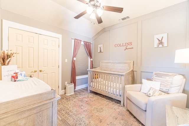 404 SW 21st St, Seminole, TX 79360 - bedroom featuring a closet, a nursery area, ceiling fan, light wood-style flooring, and a decorative wall
