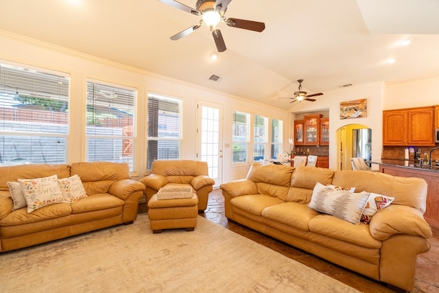 404 SW 21st St, Seminole, TX 79360 - living area with ceiling fan, arched walkways, crown molding, recessed lighting, and vaulted ceiling
