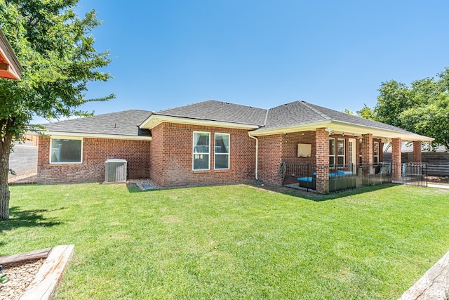 404 SW 21st St, Seminole, TX 79360 - back of property featuring cooling unit, brick siding, roof with shingles, and a patio
