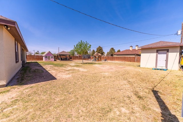 11332 W 23rd St, Odessa, TX 79763 - view of yard featuring a playground, a gazebo, and an outbuilding
