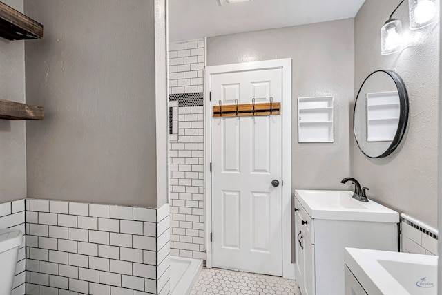 14038 W County Rd 123, Odessa, TX 79765 - full bathroom with tile patterned flooring, tiled shower, vanity, and tile walls