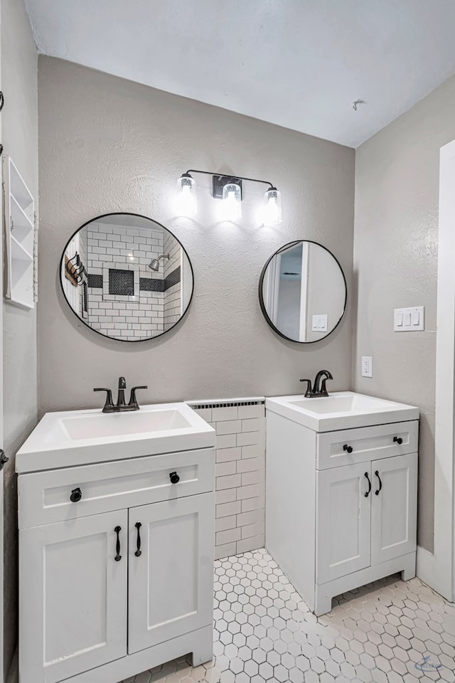 14038 W County Rd 123, Odessa, TX 79765 - full bathroom featuring two vanities, a textured wall, and tile patterned flooring
