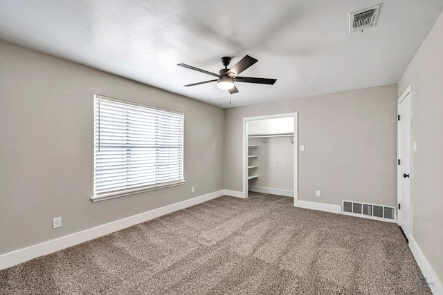 14038 W County Rd 123, Odessa, TX 79765 - unfurnished bedroom featuring carpet floors, ceiling fan, a spacious closet, and a closet