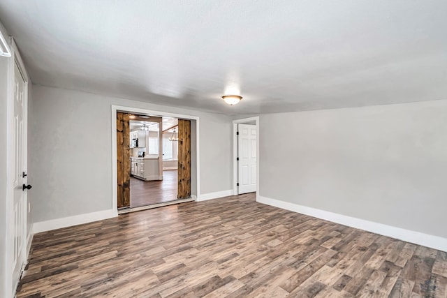 14038 W County Rd 123, Odessa, TX 79765 - empty room featuring wood finished floors and baseboards