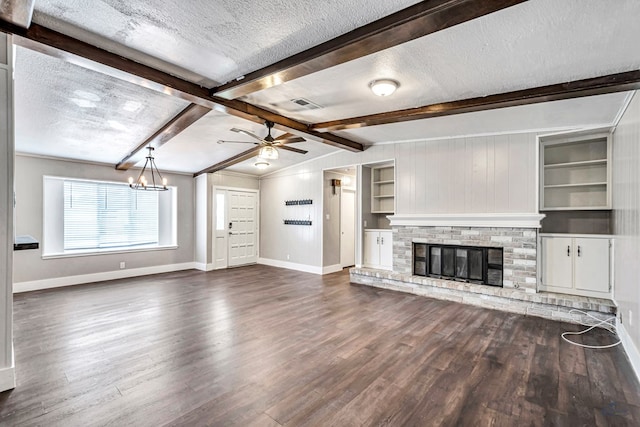 14038 W County Rd 123, Odessa, TX 79765 - unfurnished living room with a textured ceiling, dark wood-style floors, beam ceiling, ceiling fan, and a chandelier