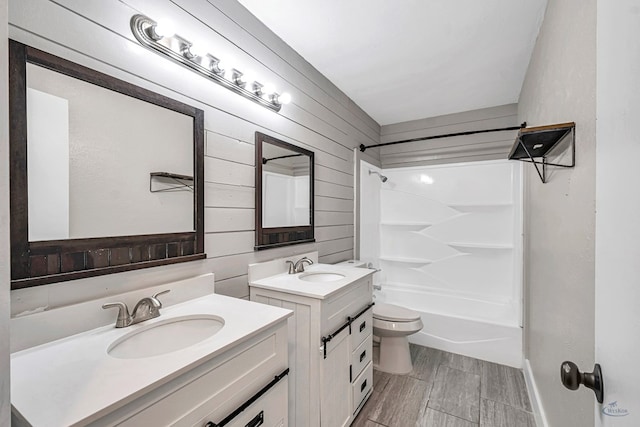 14038 W County Rd 123, Odessa, TX 79765 - bathroom featuring two vanities, wooden walls,  shower combination, and wood finish floors