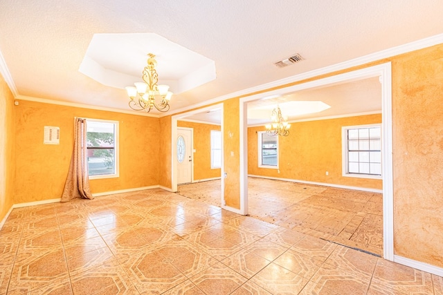 tiled spare room featuring visible vents, an inviting chandelier, crown molding, a tray ceiling, and baseboards