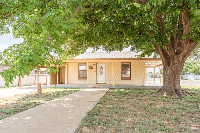 ranch-style house featuring fence and brick siding