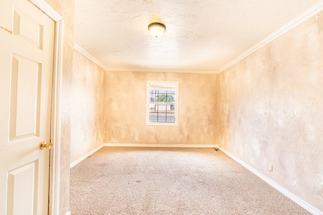 spare room with carpet, a textured ceiling, baseboards, and crown molding
