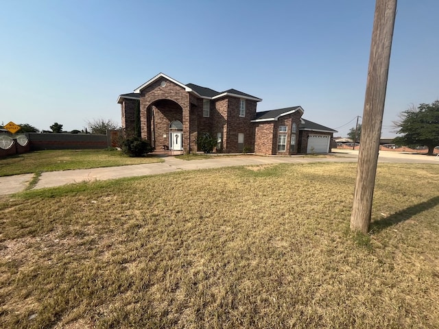 7311 Westmoore Rd, Odessa, TX 79764 - traditional-style home with driveway, brick siding, a front lawn, and an attached garage