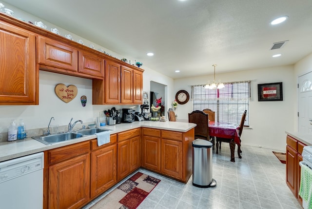 401 Brookover Cir, Odessa, TX 79763 - kitchen with dishwasher, light countertops, a chandelier, brown cabinets, and recessed lighting