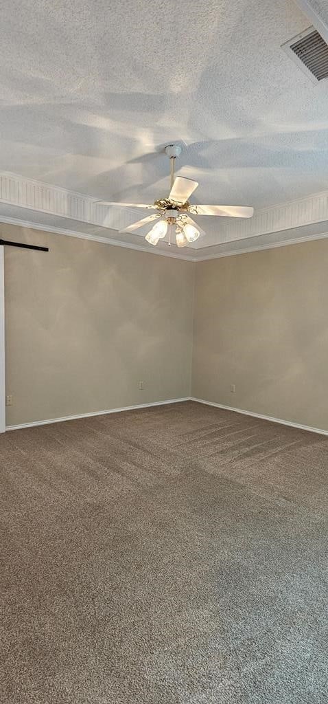 2304 Regal Pl, Midland, TX 79707 - empty room with ceiling fan, carpet, baseboards, and a textured ceiling