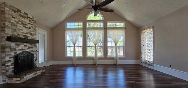 2304 Regal Pl, Midland, TX 79707 - unfurnished living room featuring ceiling fan, dark wood finished floors, a fireplace, a textured ceiling, and baseboards