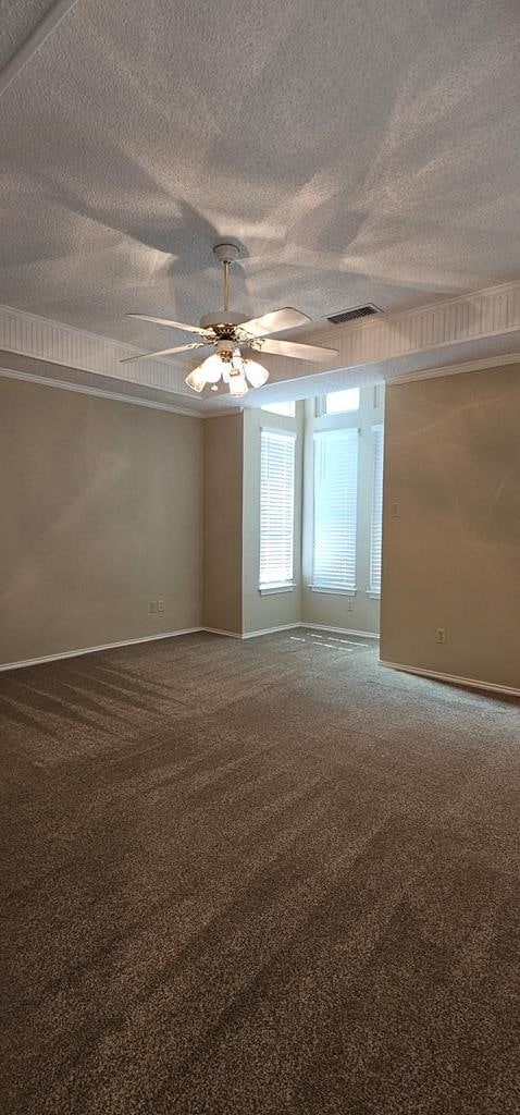 2304 Regal Pl, Midland, TX 79707 - carpeted empty room featuring ceiling fan, baseboards, and a textured ceiling