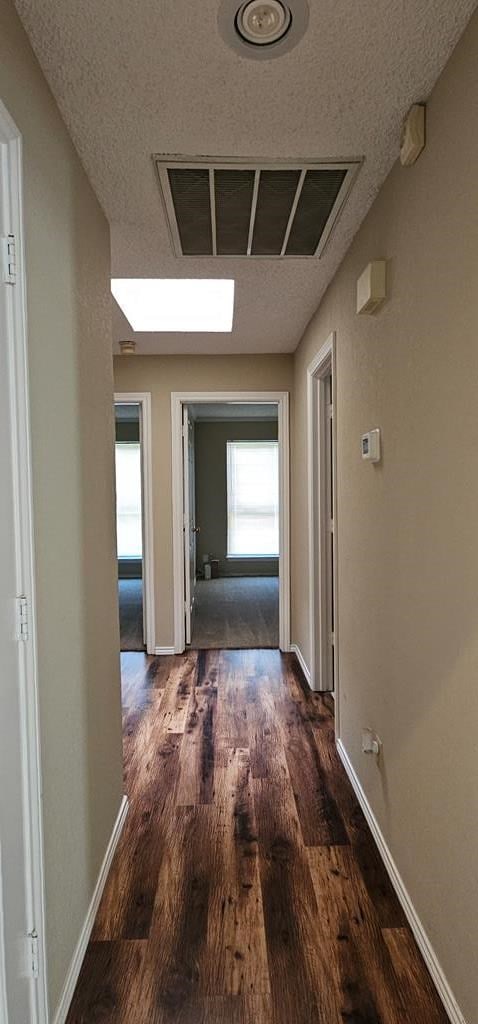 2304 Regal Pl, Midland, TX 79707 - corridor featuring wood finished floors and baseboards