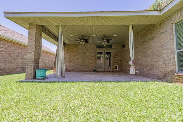 104 Waimea Dr, Odessa, TX 79762 - doorway to property featuring french doors, a ceiling fan, a yard, and brick siding