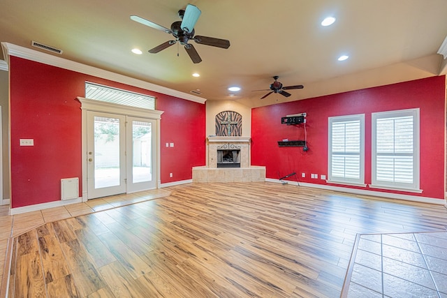 104 Waimea Dr, Odessa, TX 79762 - unfurnished living room with light wood-type flooring, ceiling fan, recessed lighting, ornamental molding, and a tile fireplace