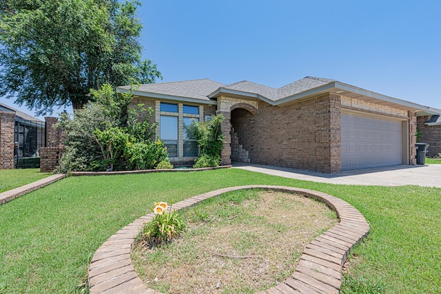 104 Waimea Dr, Odessa, TX 79762 - view of front of property with an attached garage, concrete driveway, a front lawn, and brick siding