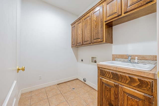 104 Waimea Dr, Odessa, TX 79762 - laundry room with electric dryer hookup, cabinet space, washer hookup, and light tile patterned floors