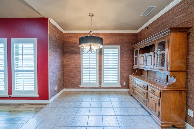104 Waimea Dr, Odessa, TX 79762 - unfurnished dining area featuring a chandelier, ornamental molding, and light tile patterned floors