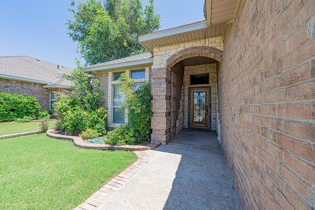 104 Waimea Dr, Odessa, TX 79762 - entrance to property featuring brick siding, a lawn, and stone siding