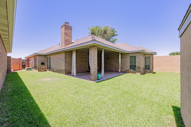 104 Waimea Dr, Odessa, TX 79762 - rear view of house featuring a chimney, a fenced backyard, a patio area, and brick siding