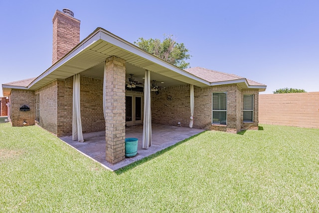 104 Waimea Dr, Odessa, TX 79762 - rear view of house with a chimney, ceiling fan, a patio area, brick siding, and roof with shingles