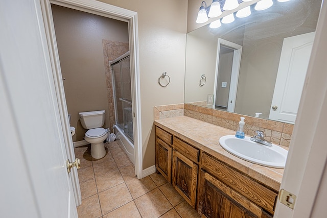 104 Waimea Dr, Odessa, TX 79762 - bathroom featuring vanity, tile patterned flooring, and bath / shower combo with glass door