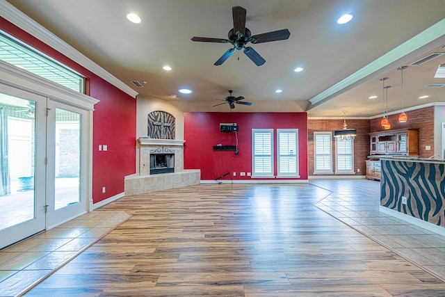 104 Waimea Dr, Odessa, TX 79762 - unfurnished living room with ornamental molding, ceiling fan, recessed lighting, wood finished floors, and a tile fireplace