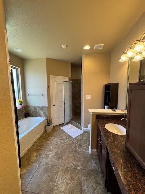 6111 Sun Tea Way, Midland, TX 79705 - bathroom with vanity, a shower stall, a bath, tile patterned flooring, and recessed lighting