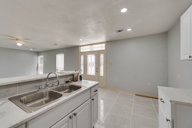 1009 S Terrell St, Midland, TX 79701 - kitchen featuring recessed lighting, white cabinets, light tile patterned floors, and ceiling fan
