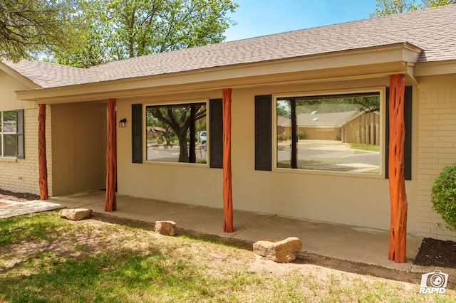 3201 Reo Dr, Midland, TX 79705 - doorway to property with brick siding, a shingled roof, and a porch