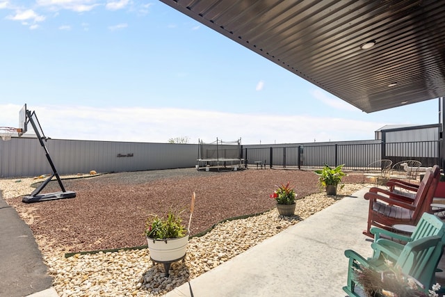 3398 SE 3000, Andrews, TX 79714 - view of patio with a trampoline and a fenced backyard