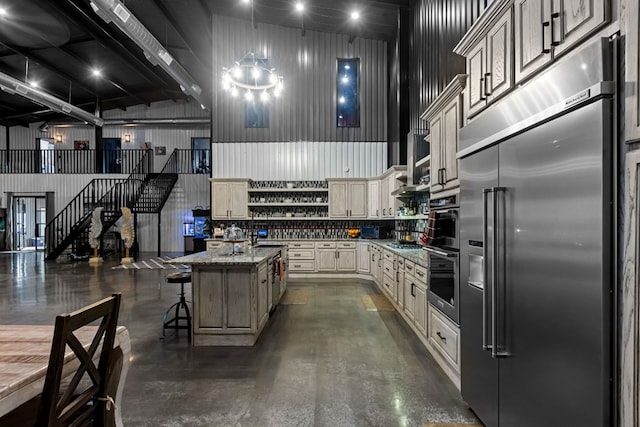 3398 SE 3000, Andrews, TX 79714 - kitchen with stainless steel appliances, open shelves, finished concrete flooring, light stone countertops, and a kitchen breakfast bar