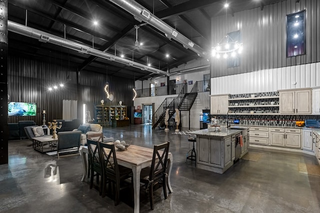 3398 SE 3000, Andrews, TX 79714 - dining area featuring a towering ceiling, concrete floors, and stairway