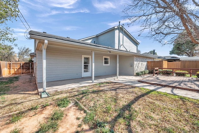 rear view of property with a patio and fence