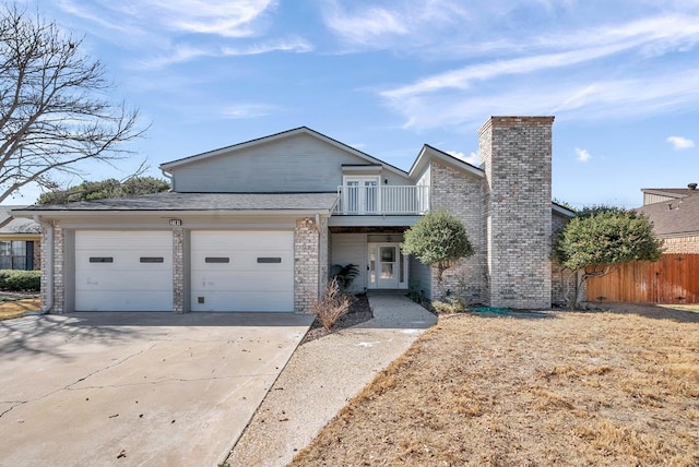 view of front of home featuring an attached garage, a balcony, fence, concrete driveway, and a chimney