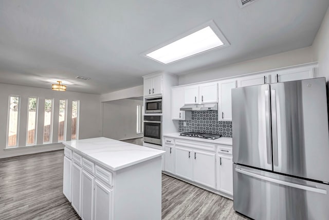 kitchen featuring appliances with stainless steel finishes, visible vents, white cabinets, and under cabinet range hood