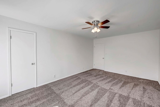 spare room featuring carpet floors and a ceiling fan