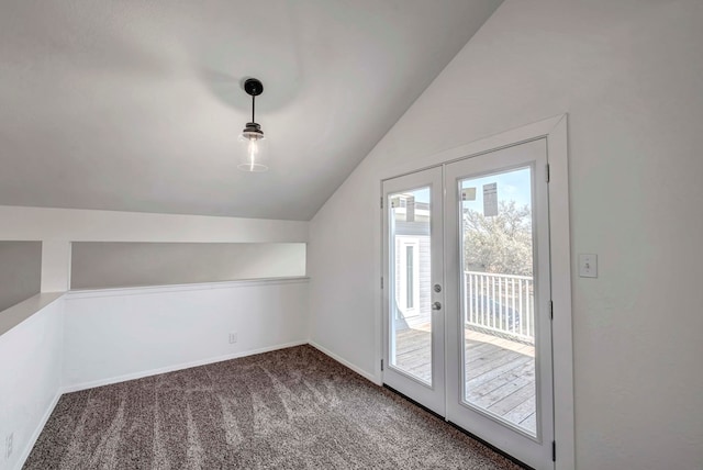 bonus room with lofted ceiling, dark colored carpet, french doors, and baseboards