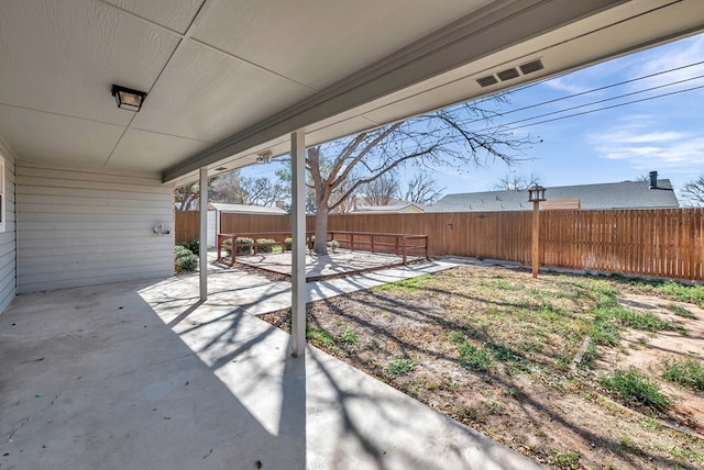 exterior space featuring a storage unit and a fenced backyard