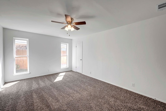 unfurnished room with baseboards, visible vents, ceiling fan, and carpet flooring