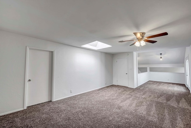 bonus room featuring carpet floors, a skylight, and a ceiling fan