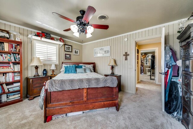 2919 Kirkwood Dr, Odessa, TX 79762 - bedroom featuring light carpet, crown molding, ceiling fan, and wooden walls