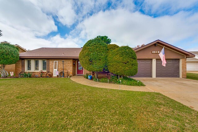 2919 Kirkwood Dr, Odessa, TX 79762 - view of front facade featuring brick siding, concrete driveway, a front yard, and an attached garage