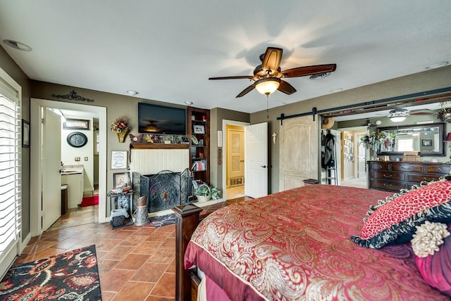 2919 Kirkwood Dr, Odessa, TX 79762 - bedroom featuring connected bathroom and a barn door